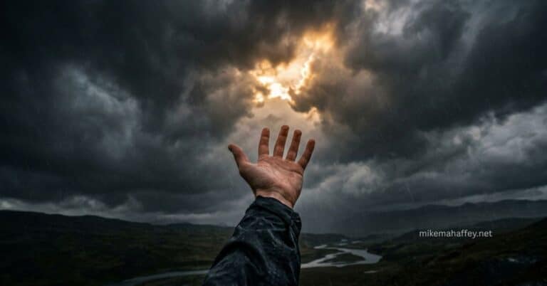 A hand reaching upward through rain toward a break in dark storm clouds where golden light is breaking through, capturing the cry and the faith of someone asking when God doesn't heal you.