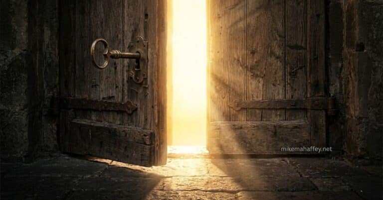 An ancient brass key in the lock of a massive weathered wooden door standing open with overwhelming golden light flooding through the gap, illustrating the cross of Christ as the door through which every blessing from God flows.