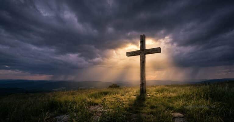 A weathered wooden cross stands alone on a hilltop under dark storm clouds, with rays of golden light breaking through behind it, connecting the darkness of sin laid on Christ to the light of the righteousness received through the Cross.