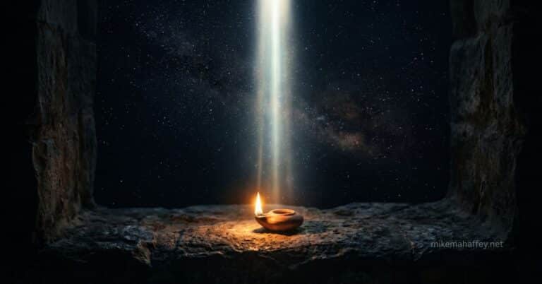 A brilliant beam of light descends from a vast starlit sky through an ancient stone opening onto a small clay oil lamp burning on rough stone, illustrating the moment God entered human limitation without ceasing to be God.